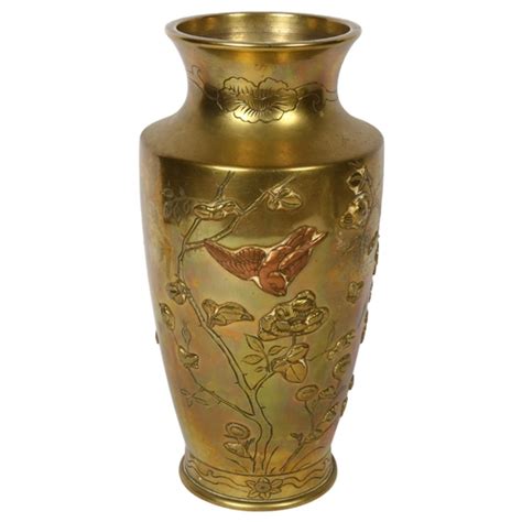 A Japanese Polished Brass Vase With Embossed Floral And Bird Decoration 30 5cm