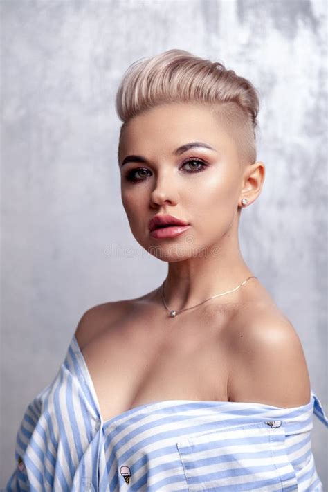 Closeup Blonde Model With Bright Make Up Leather Pants And Short Hair With Shaved Temples In