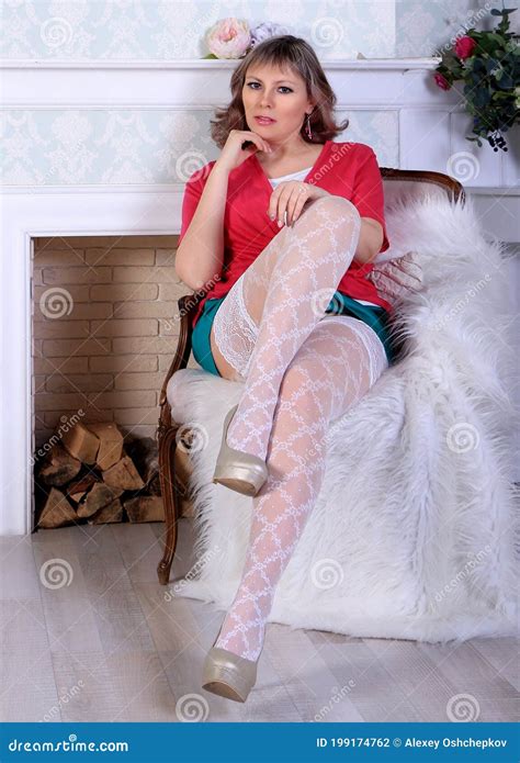 Blonde Model In White Stockings And Green Miniskirt Posing In Studio Stock Photo Image Of Face