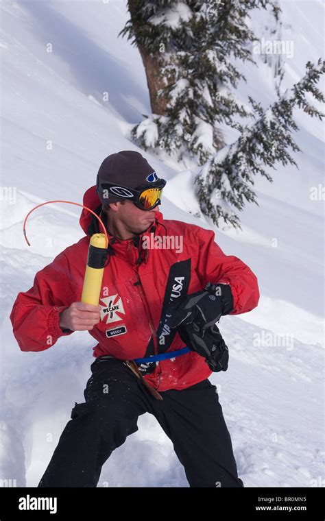 A ski patroller throwing explosives for avalanche control at Squaw ...