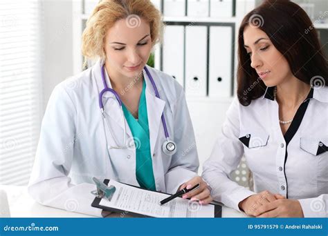 Happy Blonde Female Doctor And Patient Discussing Medical Examination Results Medicine