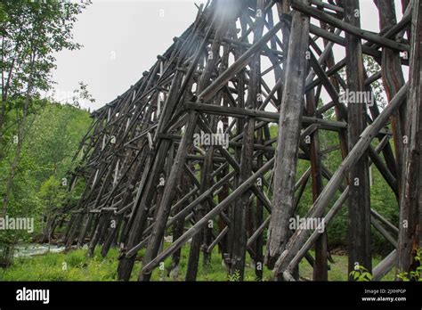 Old Wooden Railroad trestle bridge over the river; Skagway, Alaska ...