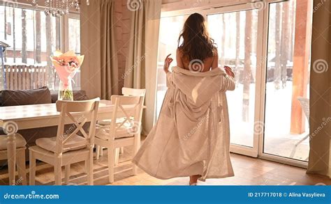 Beautiful Slim Naked Woman Long Hair Goes To Panoramic Windows Slowly Taking Off The White