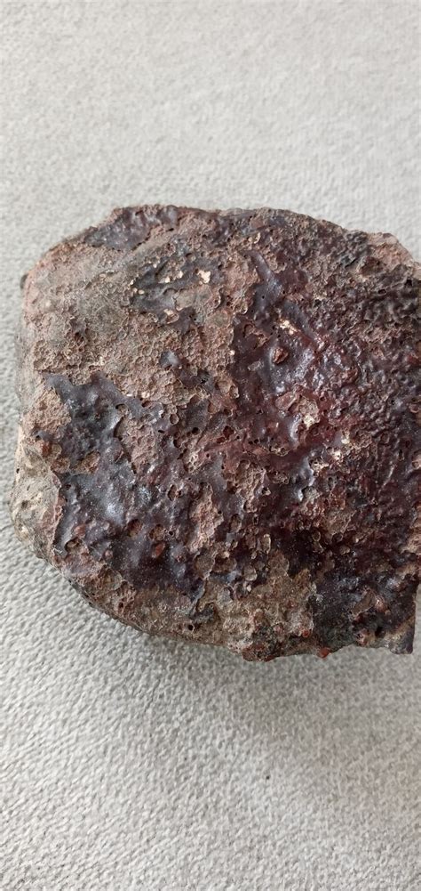 A Rock Sitting On Top Of A Carpet Covered Floor