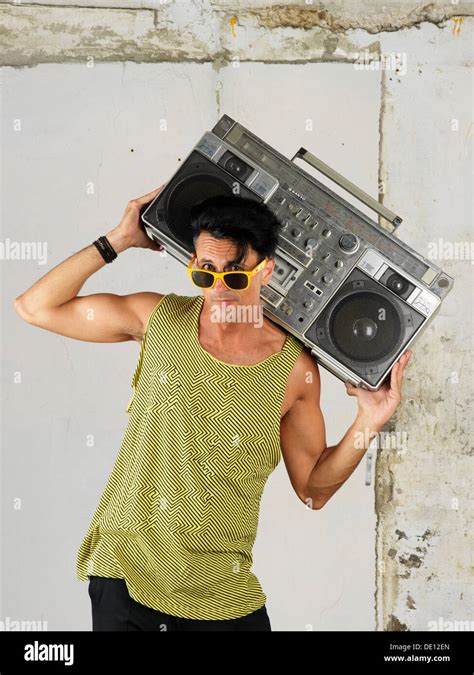 Foolish Guy Carrying A Big Portable Old Radio On His Shoulder Or On