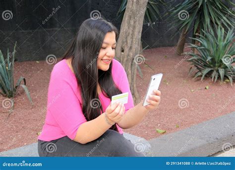 Year Old Latina Woman Uses Credit Card And Cell Phone To Make Purchases And Payments Online