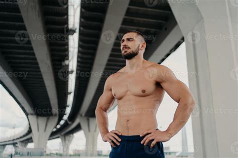 Athletic Male Fitness Model Keeps Hands On Waist Poses With Muscular Perfect Naked Body Looks