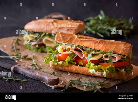 Baguette Bread Sandwich With Cheese Ham Tomatoes And Vegetables Stock