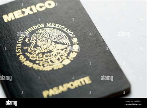 Closeup Of Green Cover Of Mexican Passport Against White Surface With