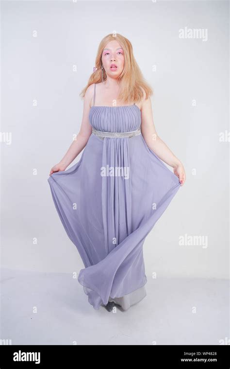 Cute Fashion Lady With Asian Face And Blonde Hair In Gray Dress Stock