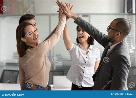 Excited Young Female Team Leader Giving High Five To Colleagues Stock