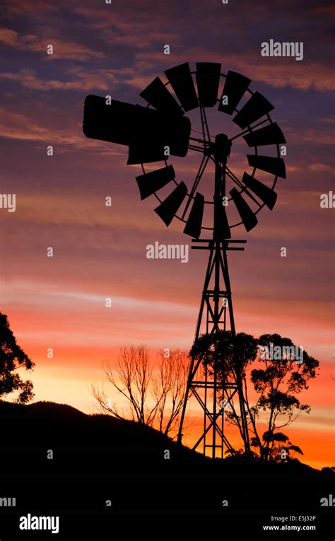 Windmill silhouette and sunset Stock Photo - Alamy