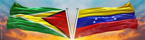 Guyana flag and Venezuela Flag waving with texture sky Cloud and sunset ...