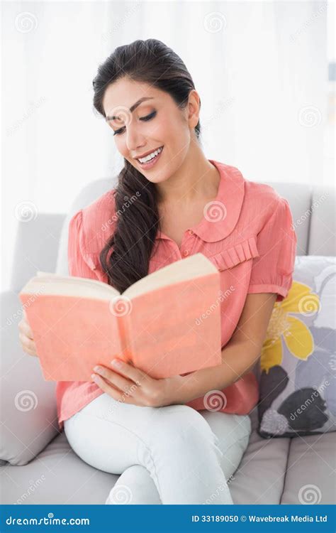 Content Brunette Sitting On Her Sofa Reading A Book Stock Photo Image Of Hair Calm