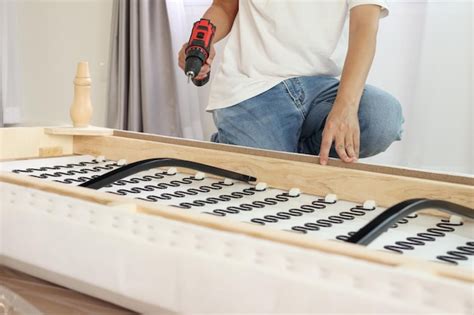 Premium Photo Man Assembling Sofa Furniture At Home Using Cordless