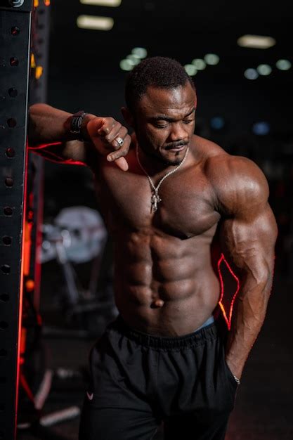 Premium Photo Fitness Male Model With Naked Torso Poses To The Camera On Gym Background