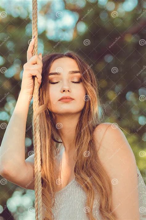 Portrait Of Beautiful Female Face Near Ropes Of Swing Girl Swinging On