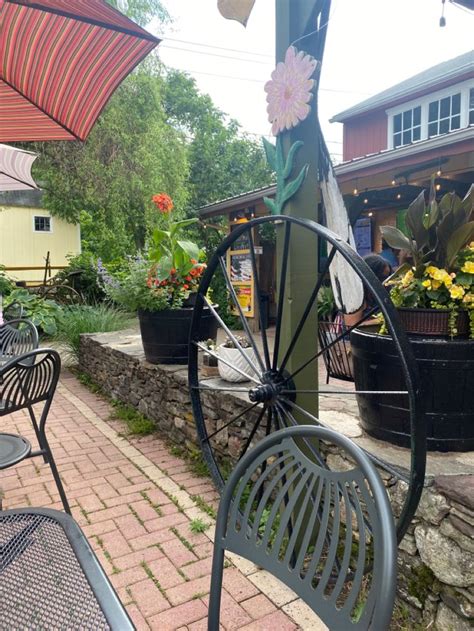 An Outdoor Patio Area With Tables And Chairs