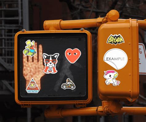 An Orange Traffic Light With Stickers On It