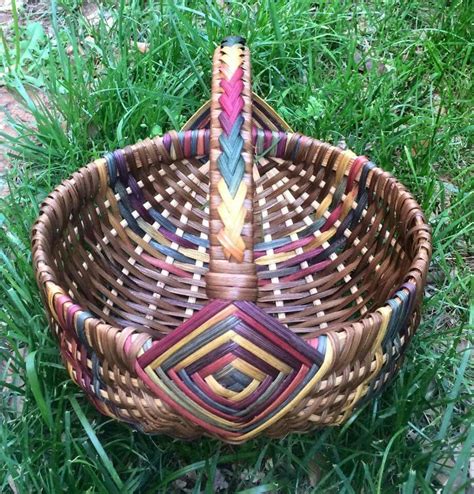 a woven basket sitting in the grass