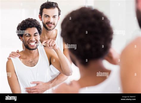 Reflection Of Happy Gay Couple In Bathroom Stock Photo Alamy