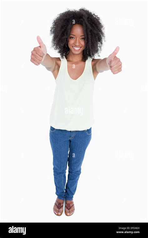 Young Relaxed Woman Standing Upright With Her Thumbs Up Stock Photo Alamy