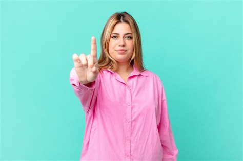 Premium Photo Curvy Pretty Blonde Woman Smiling And Looking Friendly Showing Number One