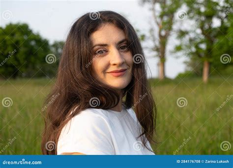 Portrait Of A 35 Year Old Brunette Woman Looking At The Camera Smiling