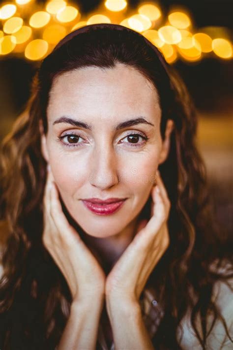 Close Up Of Pretty Brunette With Hands Under Her Chin Looking At Camera Stock Image Image Of