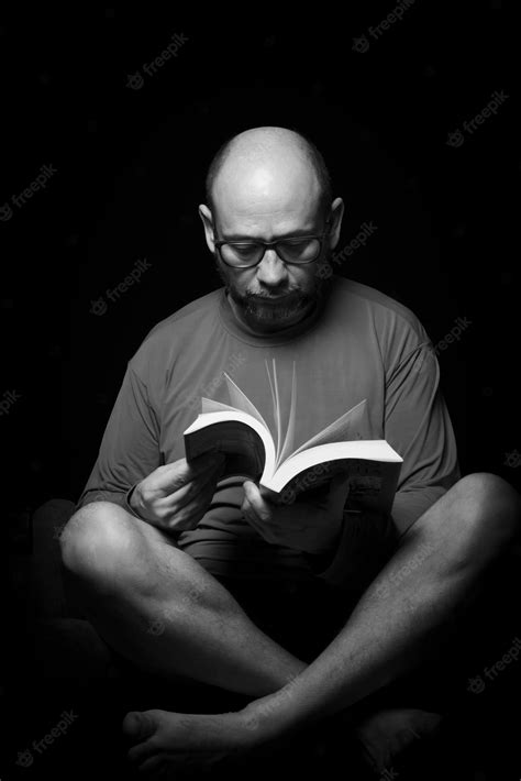 Premium Photo Portrait Of A Bearded Bald Man Reading A Book Against