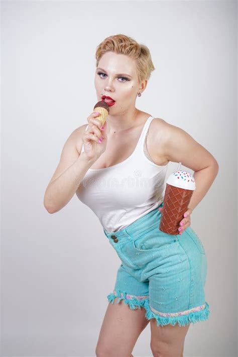 Jolie Fille Blonde Caucasienne De Cheveux Courts Mangeant De La Glace Savoureuse Avec Le C Ne De