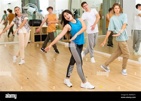 Happy Brunette Teenage Girl Practicing Vigorous Dance With Group Stock Photo Alamy