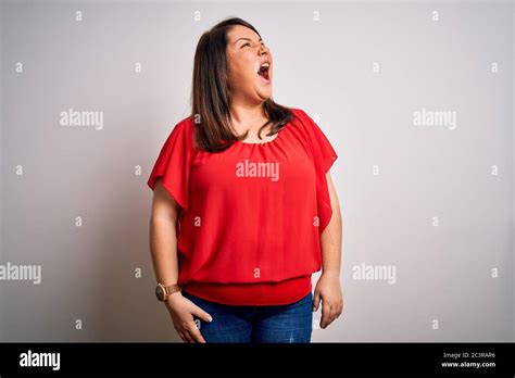Beautiful Brunette Plus Size Woman Wearing Casual Red T Shirt Over Isolated White Background