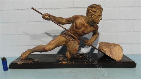 LARGE FRENCH ART DECO STATUE OF A SEMI NUDE MAN PUSHING A ROCK BY