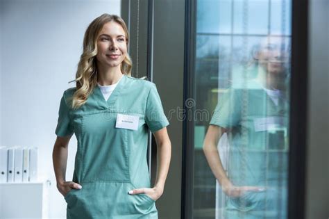 Cute Long Haired Blonde Caucasian Woman In Lab Coat In The Clinic Corridor Stock Image Image
