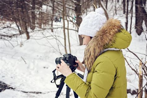 Woman Amateur Photographer Takes A Winter Landscape On The Lake In The Forest Copy Space Stock