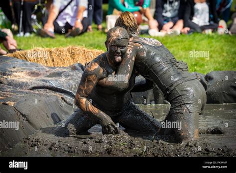 Two Women Mud Wrestling At A Mud Fighting Competition At The Lowland