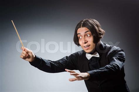 Funny conductor in musical concept | Stock image | Colourbox