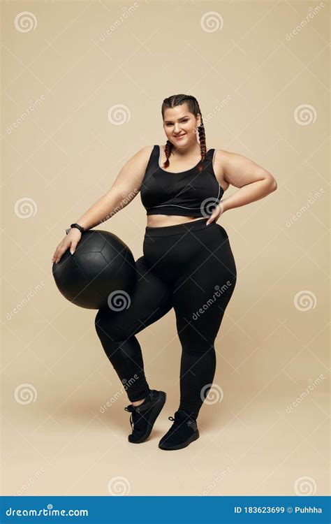 Plus Size Model Fat Woman In Black Sportswear Full Length Portrait Smiling Brunette Holding