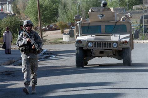 Soldiers Conduct A Routine Security Patrol On Foot And In A Humvee In