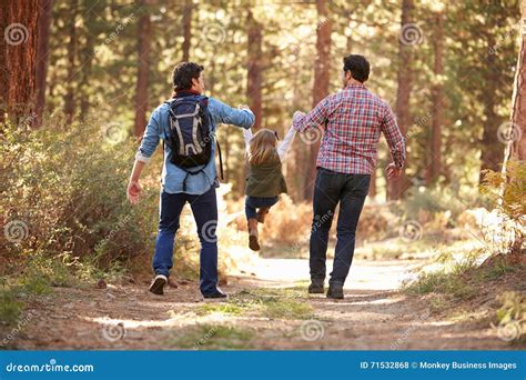 Coppie Maschii Gay Con La Figlia Che Cammina Attraverso Il Terreno Boscoso Di Caduta Fotografia