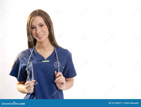 Beautiful Brunette Nurse Holds Her Stethoscope Looking At Camera Stock
