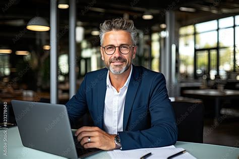 Smiling Mature Adult Business Man Executive Sitting At Desk Using Laptop Happy Busy