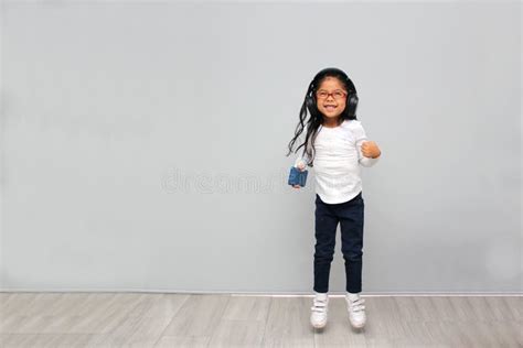 Year Old Brunette Latin Girl With Glasses Listens To Music In Her Headphones Connected To Her