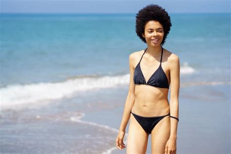 Contenu Femme Noire En Bikini Marchant En Bord De Mer Photo Stock