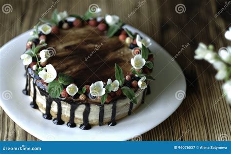 Naked Drip Cake With Chocolate Decorated With Strawberries Jasmine Flowers And Honeysuckle On