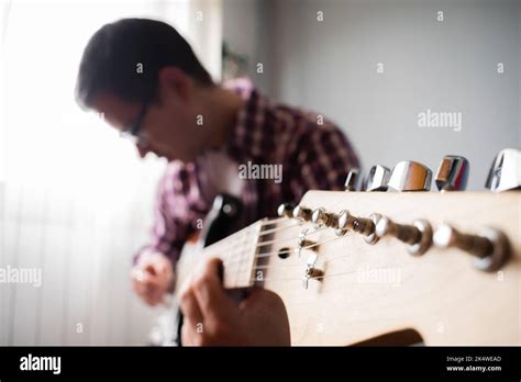 Portrait Of A Young Man With Glasses Playing An Electric Guitar Stock