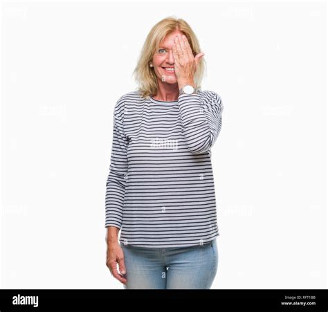 Middle Age Blonde Woman Over Isolated Background Covering One Eye With Hand With Confident Smile