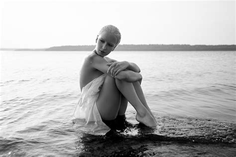 Premium Photo Art Nude Sexy Blonde With Short Haircut Is Sitting In Water On Shore Beach Of
