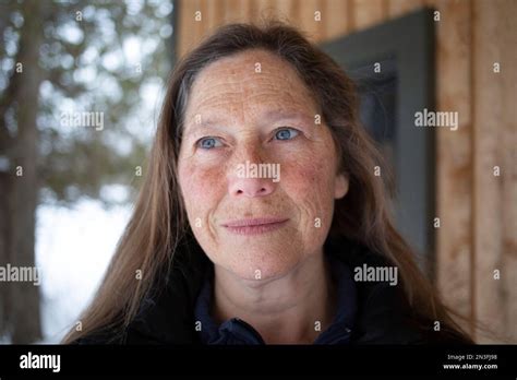 Portrait Of A Mature Woman Standing Outdoors With A Freckled Face And